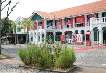 Colonial-style building in a plaza with greenery